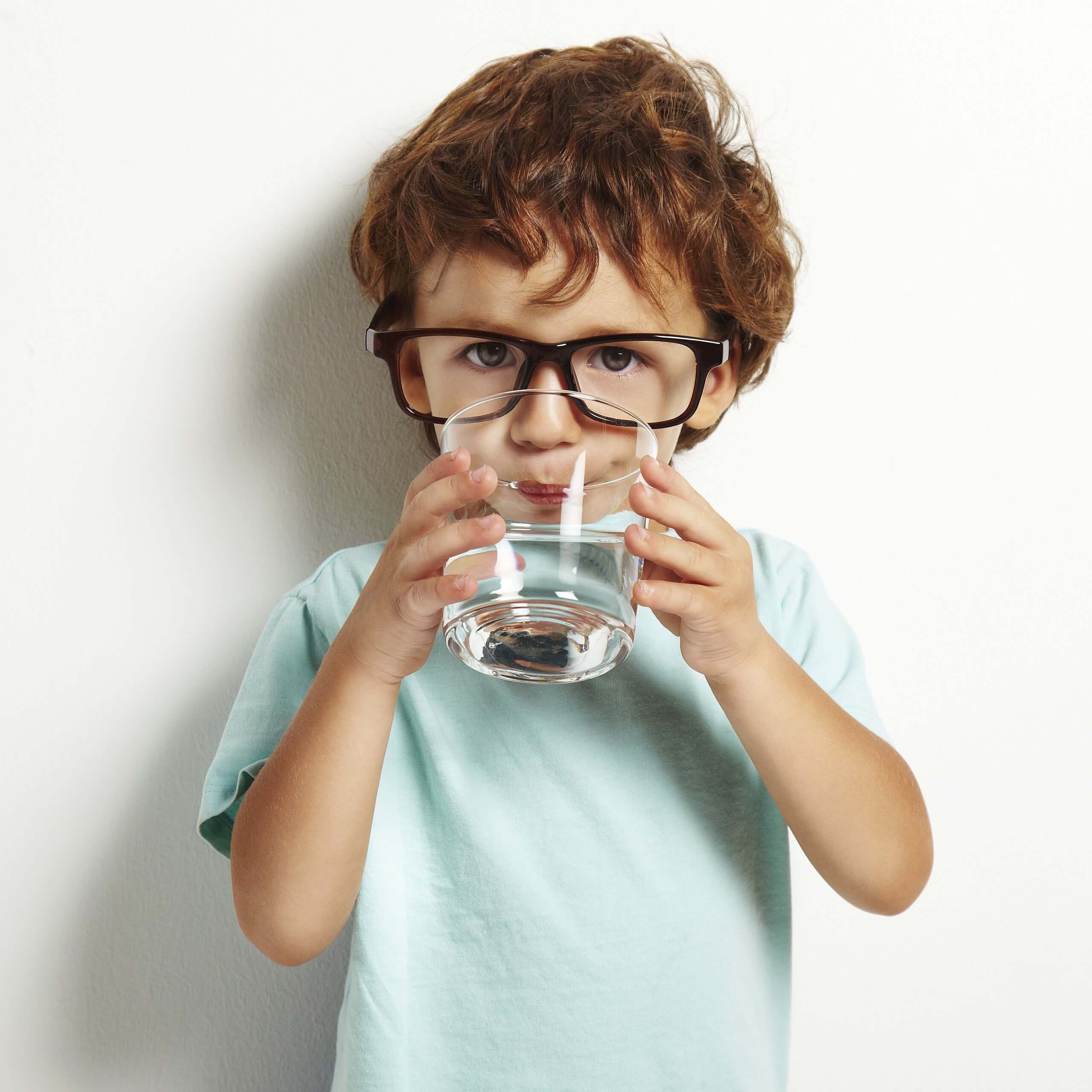 Portrait,Of,Boy,Drinking,Glass,Of,Water,Isolated,In,White